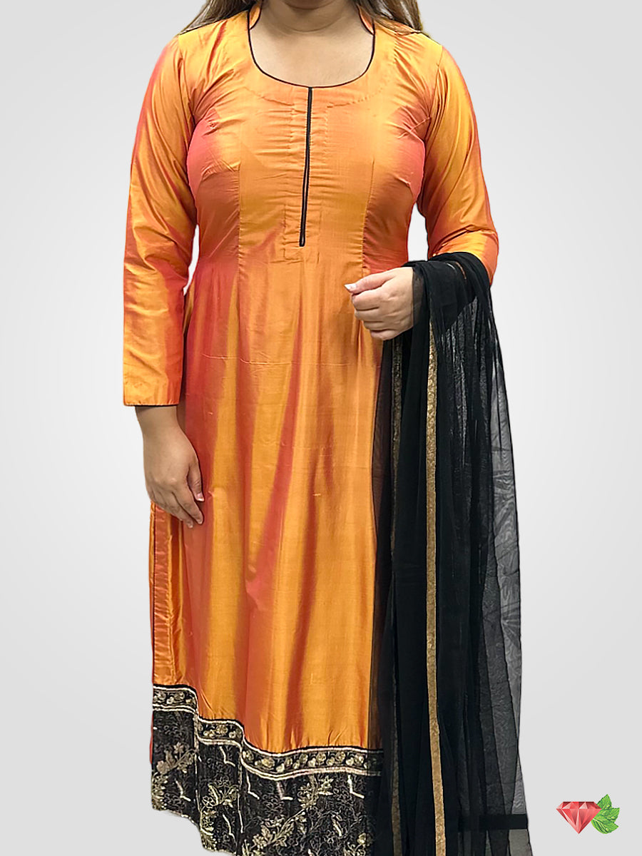 Orange silk embroidered suit paired with black Churidar and net Dupatta